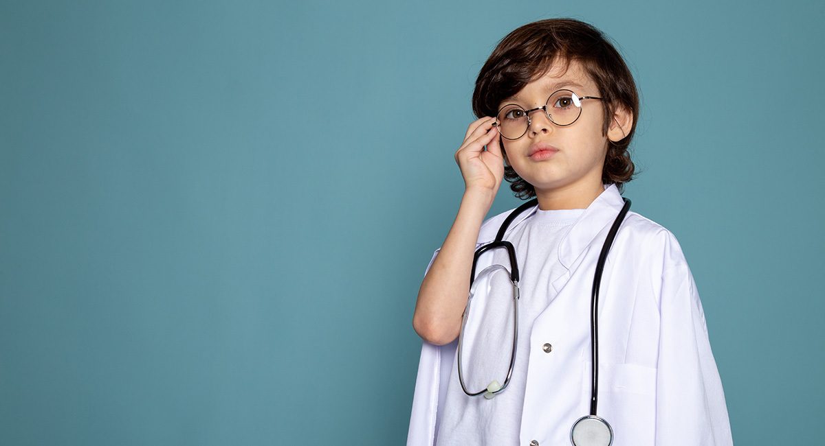 Boy cute sweet adorable child boy white medical suit sunglasses blue desk web