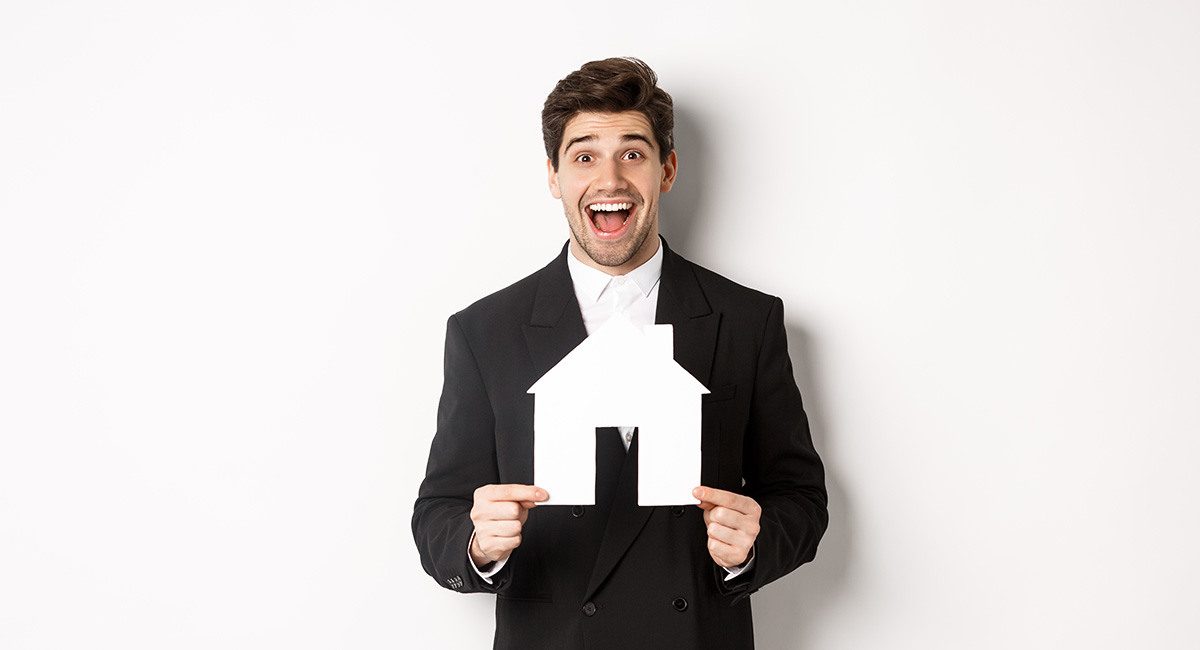 Image handsome real estate agent black suit showing home maket looking amazed selling houses standing against white background web