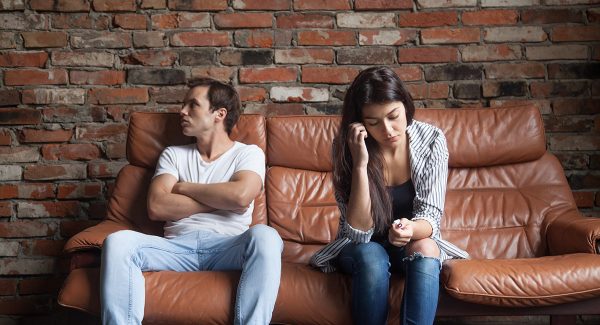 Frustrated upset couple after quarrel sitting sofa home web